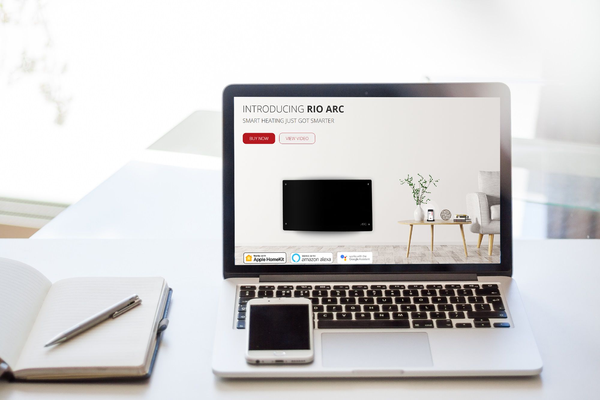 The Rio Arc product page on a laptop, with a phone and notebook on a white desk